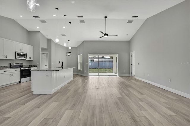 kitchen with visible vents, light wood-style floors, open floor plan, white cabinets, and appliances with stainless steel finishes