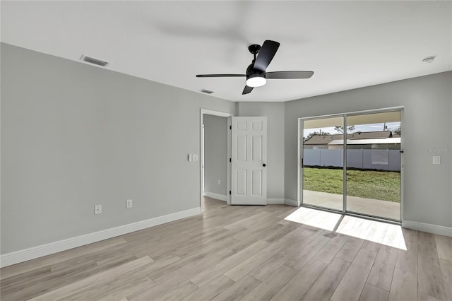 empty room with light wood-style floors, visible vents, ceiling fan, and baseboards