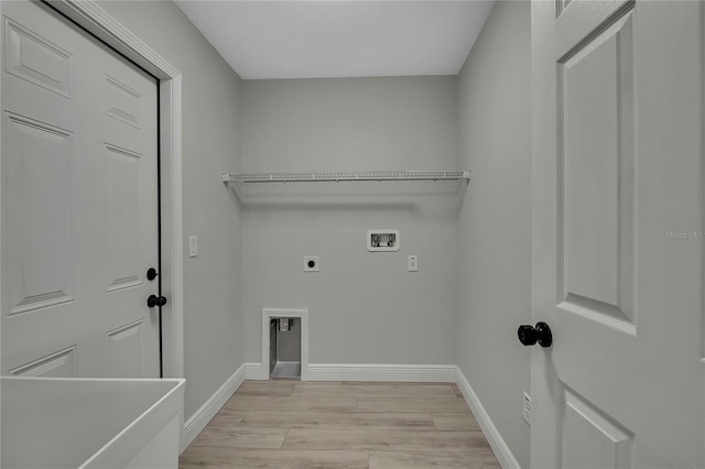 washroom featuring hookup for a washing machine, light wood-style flooring, hookup for an electric dryer, laundry area, and baseboards