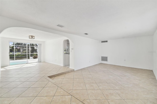 unfurnished room with light tile patterned floors