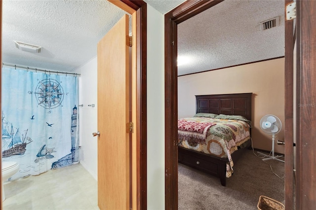 carpeted bedroom featuring a textured ceiling