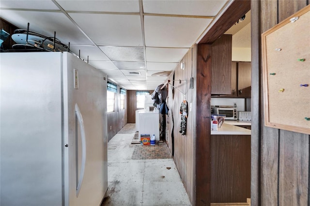 kitchen with washer / clothes dryer, refrigerator, and a drop ceiling