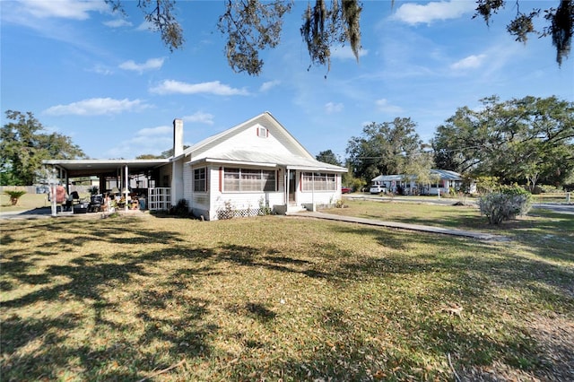 view of front facade with a front yard and a carport