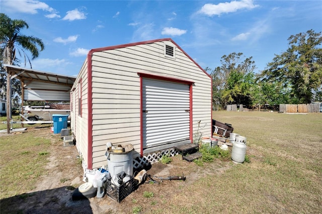 view of outbuilding with a garage and a lawn