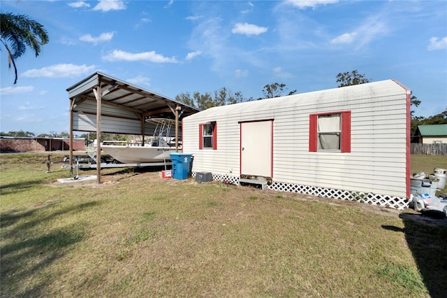 view of outdoor structure featuring a yard and a carport