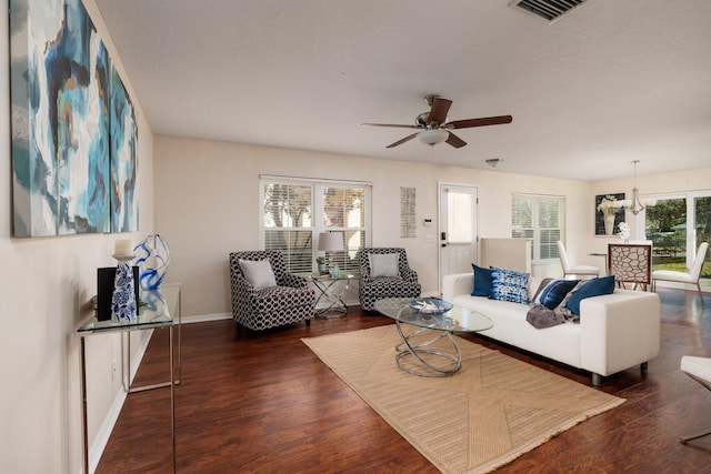 living room with ceiling fan and dark hardwood / wood-style flooring