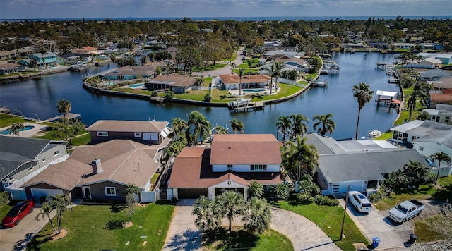 drone / aerial view featuring a residential view and a water view