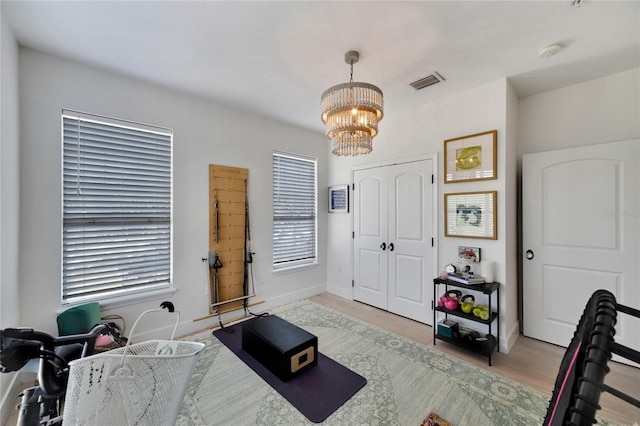 office area with a chandelier and light hardwood / wood-style flooring