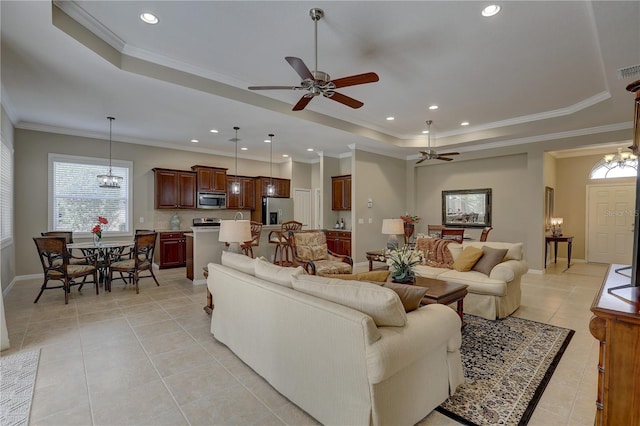 living area with recessed lighting, light tile patterned floors, crown molding, a raised ceiling, and ceiling fan with notable chandelier
