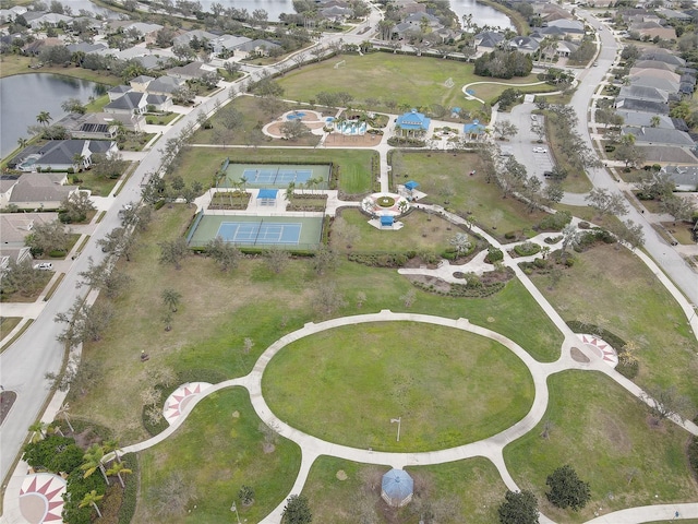 drone / aerial view featuring a residential view and a water view