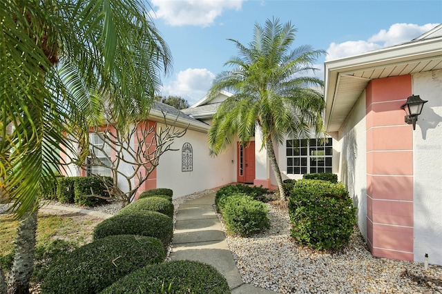 entrance to property featuring stucco siding