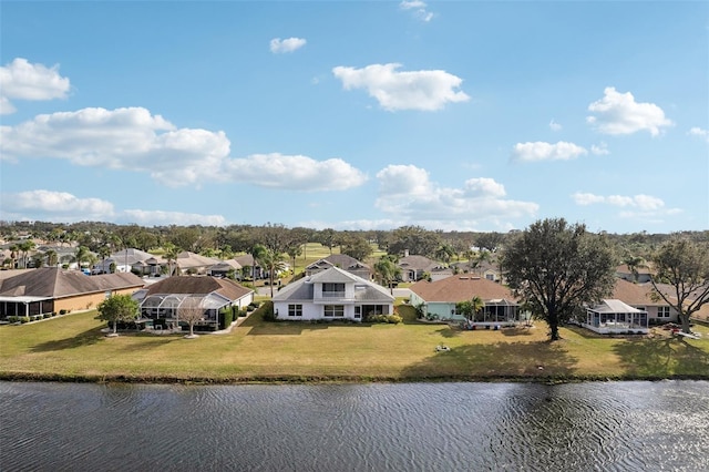 drone / aerial view with a water view and a residential view