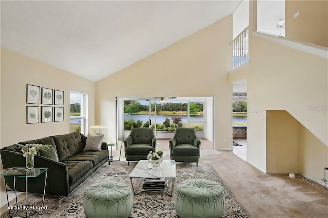 living area featuring high vaulted ceiling, plenty of natural light, and carpet flooring