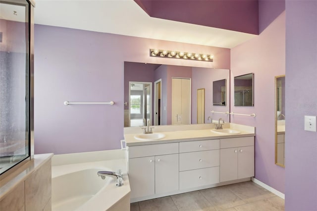 full bathroom featuring double vanity, a garden tub, and a sink