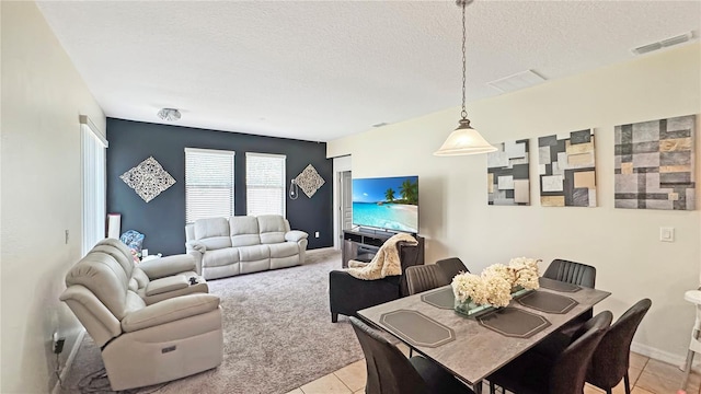 9362 Oglethorpe Dr, Groveland, FL 34736 - dining area with a textured ceiling, light tile patterned floors, and baseboards