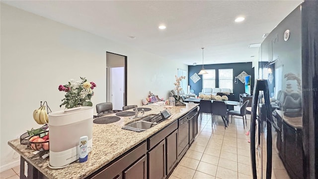 9362 Oglethorpe Dr, Groveland, FL 34736 - kitchen featuring a sink, light tile patterned flooring, open floor plan, decorative light fixtures, and light stone countertops