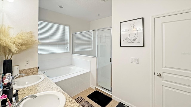 9362 Oglethorpe Dr, Groveland, FL 34736 - bathroom featuring a bath, a stall shower, double vanity, and tile patterned floors