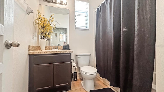 9362 Oglethorpe Dr, Groveland, FL 34736 - bathroom featuring toilet, vanity, curtained shower, and tile patterned flooring