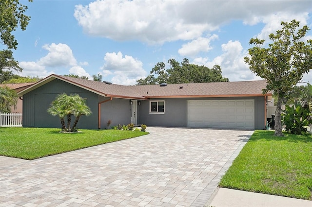 ranch-style home featuring a garage and a front yard