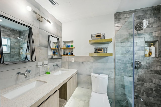 bathroom featuring tile walls, vanity, toilet, and an enclosed shower