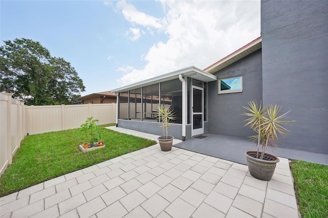 view of patio featuring a sunroom