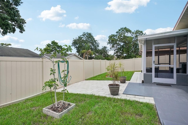 view of yard with a sunroom and a patio