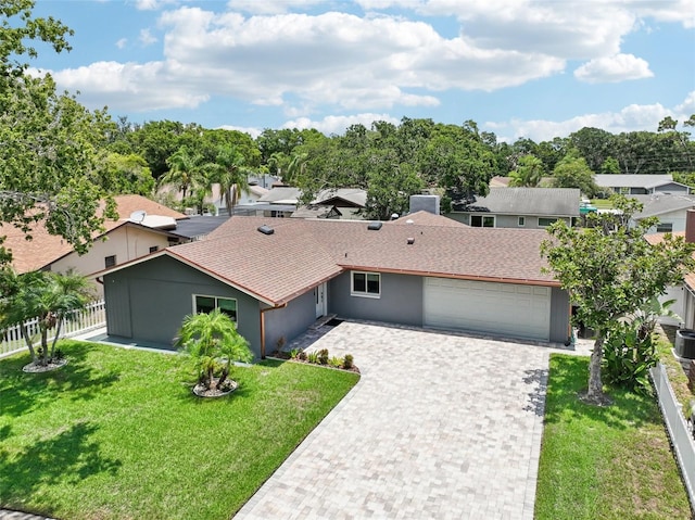 view of front of house with a garage and a front yard