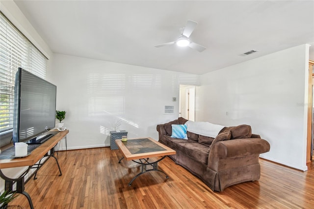 living room with ceiling fan and hardwood / wood-style floors