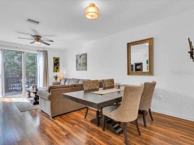 dining space with dark hardwood / wood-style floors and ceiling fan