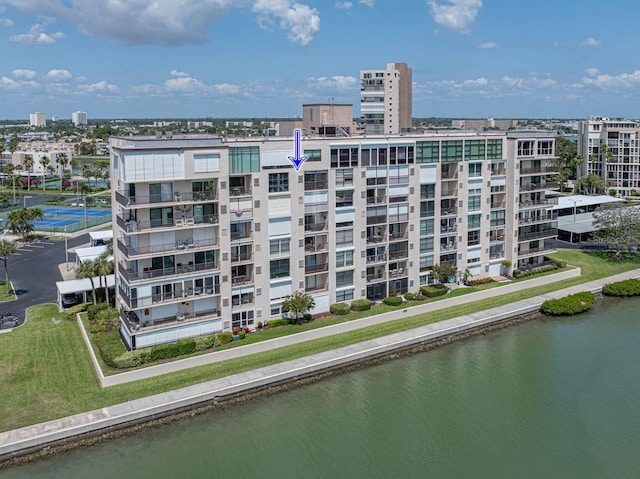 view of building exterior with a view of city and a water view