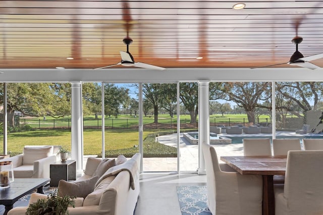 sunroom with wood ceiling and ceiling fan