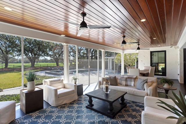 sunroom / solarium featuring wooden ceiling and ceiling fan