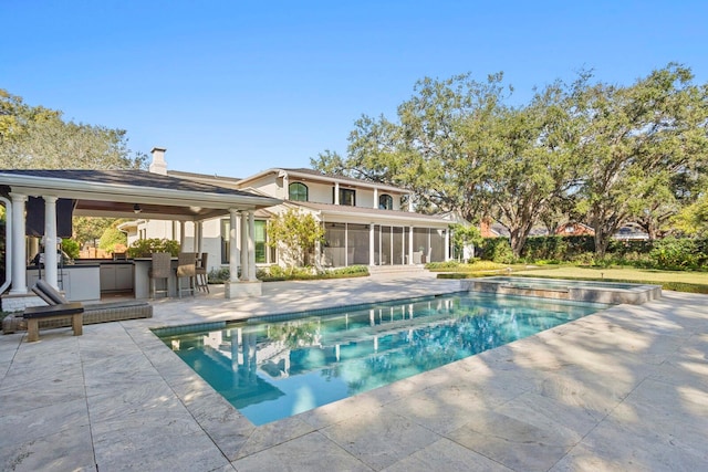 view of swimming pool featuring a gazebo, an in ground hot tub, a patio, a bar, and a sunroom