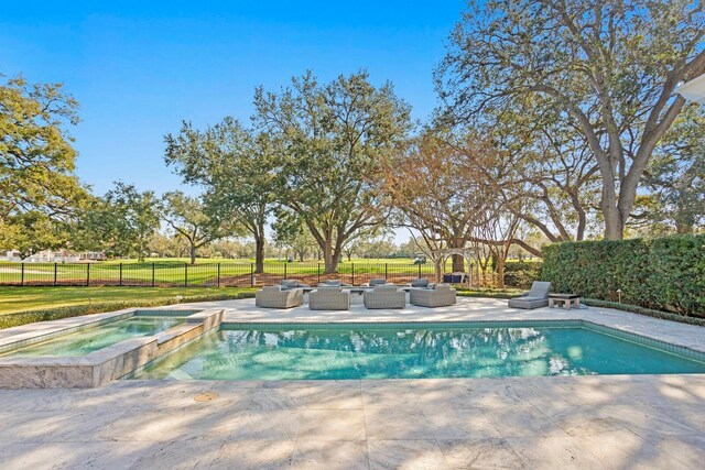 view of swimming pool with an in ground hot tub and a patio area