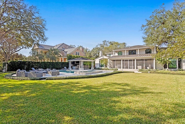 view of yard with a fenced in pool, a gazebo, and a sunroom