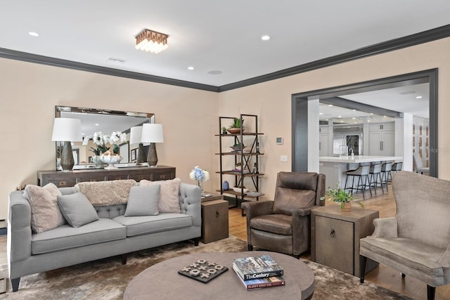 living room with crown molding and wood-type flooring