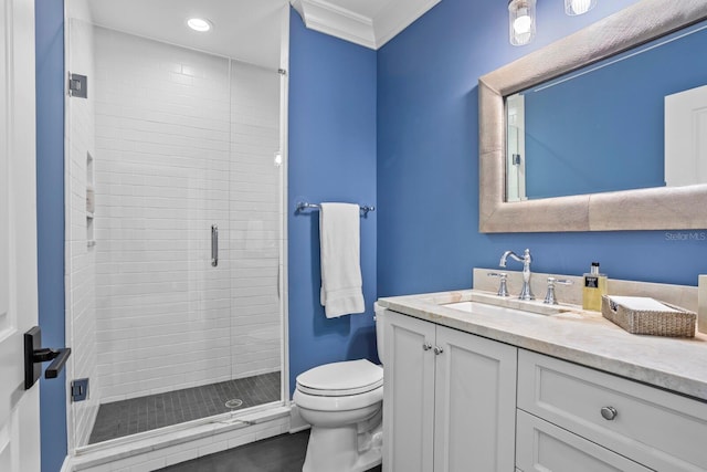 bathroom with ornamental molding, vanity, toilet, and an enclosed shower