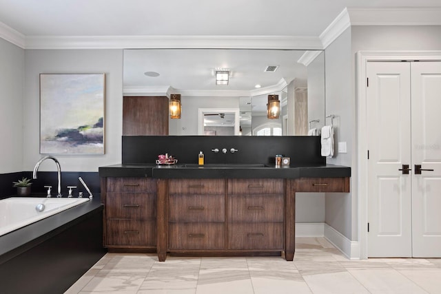 bathroom with crown molding, a washtub, and vanity