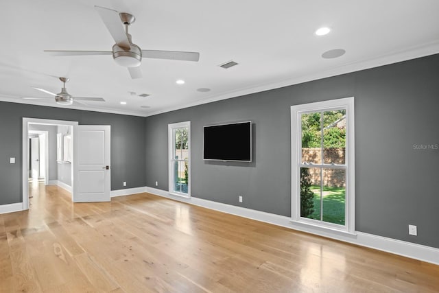 spare room featuring ceiling fan, ornamental molding, and light wood-type flooring