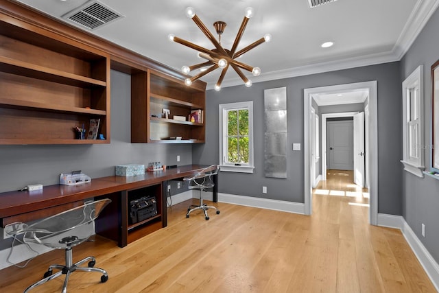 office featuring an inviting chandelier, ornamental molding, built in desk, and light wood-type flooring