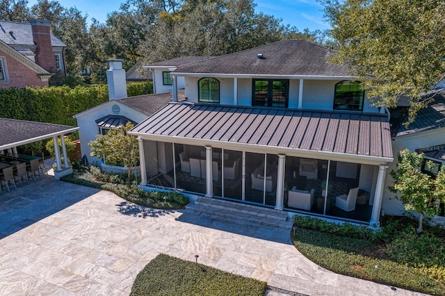 rear view of house with a sunroom