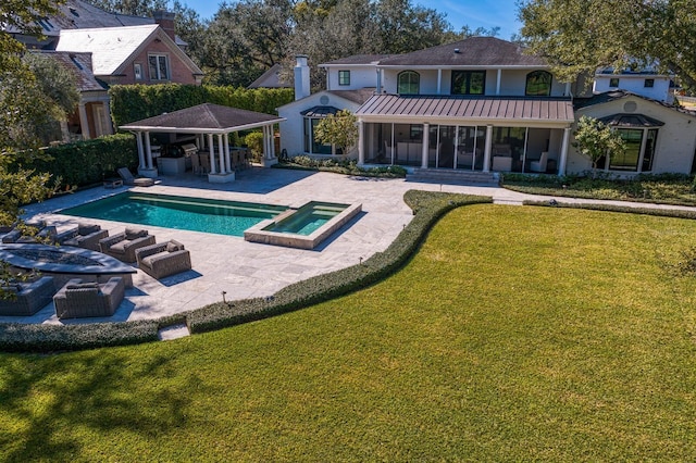 back of house with a patio, a swimming pool with hot tub, a yard, an outdoor living space, and a gazebo