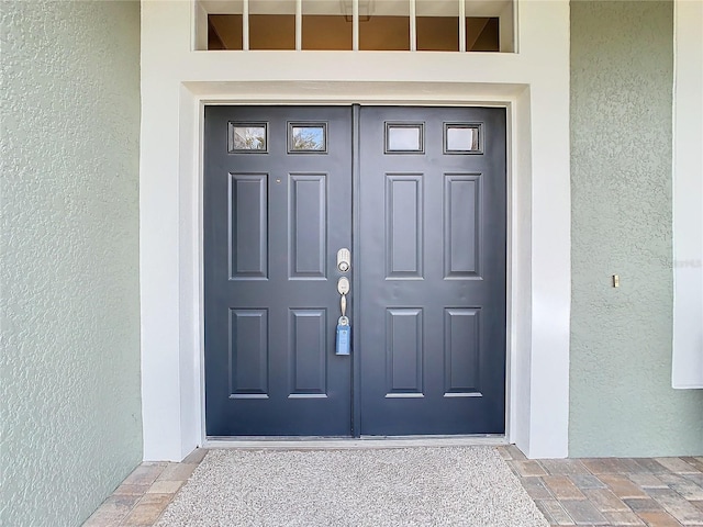 doorway to property with stucco siding