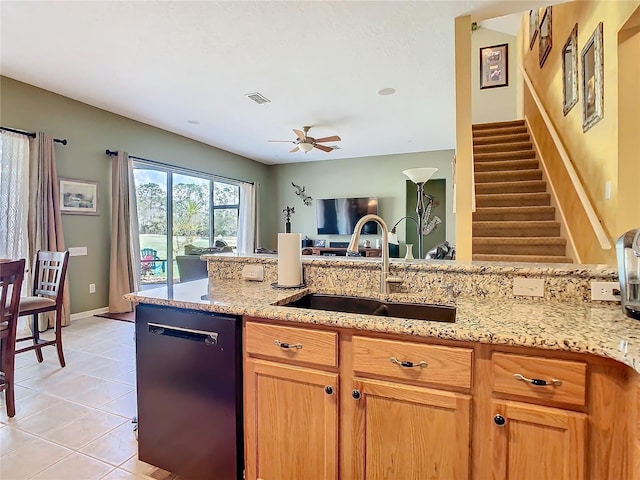 kitchen featuring light tile patterned floors, visible vents, dishwashing machine, light stone countertops, and a sink