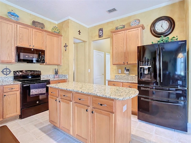 kitchen with visible vents, a kitchen island, light stone counters, ornamental molding, and black appliances