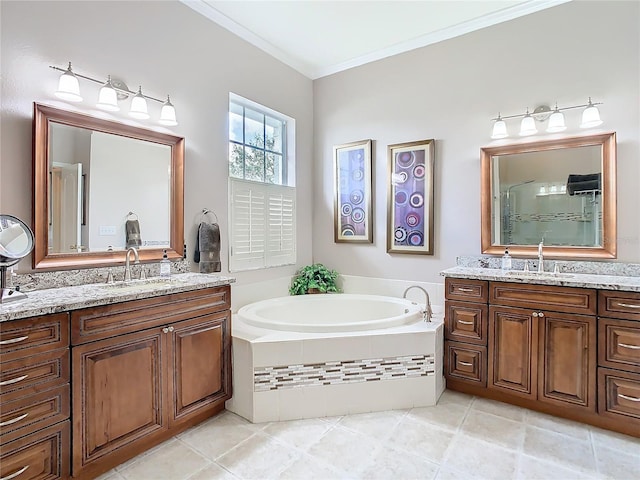 bathroom featuring a garden tub, ornamental molding, two vanities, and a sink