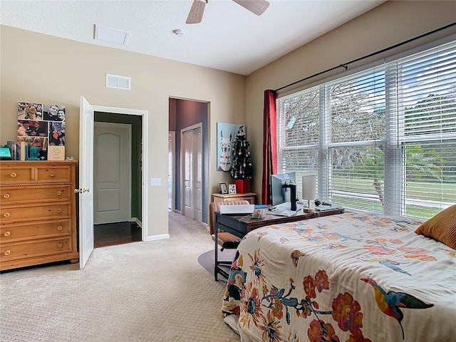 bedroom with carpet floors, baseboards, visible vents, and ceiling fan