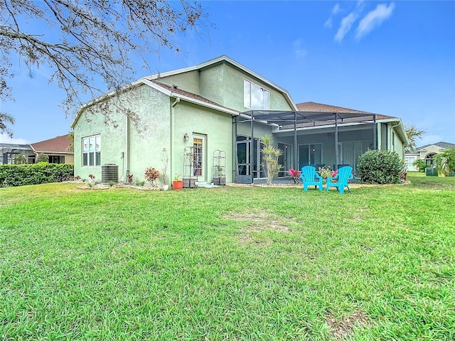 back of house featuring glass enclosure, central AC unit, stucco siding, and a yard