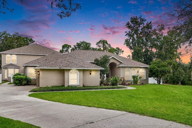 single story home featuring a yard