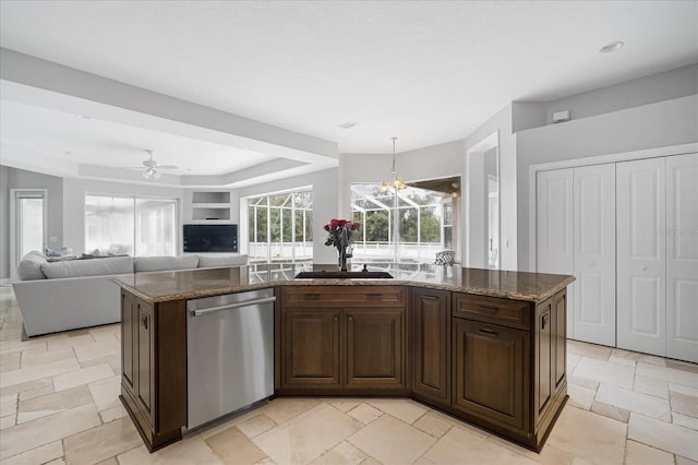 kitchen with sink, dark brown cabinets, stainless steel dishwasher, and a center island with sink